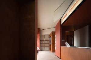 Modern office reception area with industrial design elements and wood materials