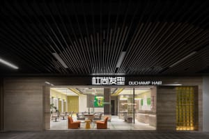 Modern interior of a concrete and glass hair salon featuring contemporary design elements.