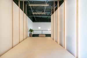 A modern minimalist living room with white paper flooring.