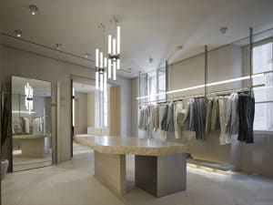 Modern retail storefront featuring marble and glass.