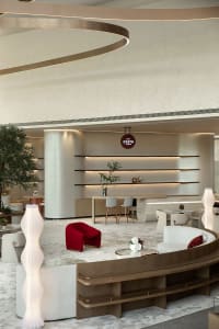 A modern commercial space featuring contemporary furniture and lighting, with a focus on minimalist design principles.