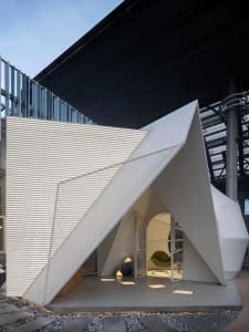 Modern architectural decoration featuring a metal structure in an outdoor setting.
