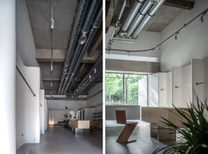 A modern lobby with concrete walls and ceiling, featuring a minimalist design.