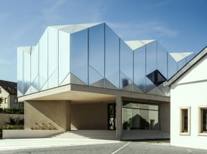 Modern residential exterior featuring glass and concrete materials
