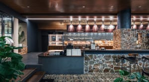Modern restaurant interior with stone, wood, and metal materials.