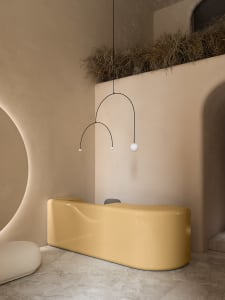 A sleek, modern reception desk made of polished, yellow concrete.