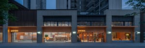 A modern storefront featuring large glass windows and a sleek, minimalist design.