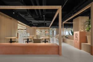 Modern minimalist cafe interior with wooden elements and minimal decor.