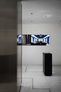 Modern minimalist interior with a glass display case and sleek, clean lines.