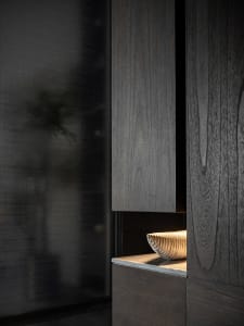 A modern living room featuring wood-textured panels, contemporary design, and sleek furniture.