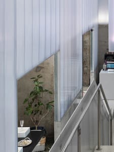Modern interior design featuring a minimalist space with concrete and glass materials.