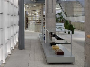 A modern retail shop featuring a transparent display counter with products arranged neatly on shelves.