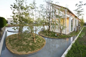 Modern residential exterior featuring concrete, wood, and glass materials