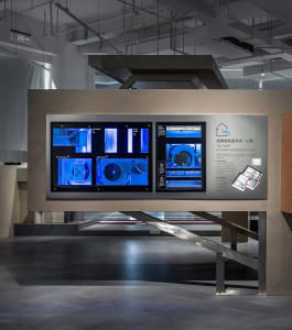 Industrial exhibition display featuring glass elements and blue lighting