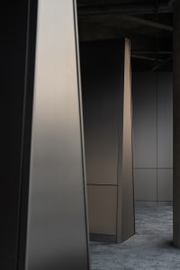 A modern, minimalist closet with metallic finish, featuring sleek lines and a monochromatic color palette, designed for effic