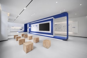 Modern office space featuring wooden furniture and geometric design elements.