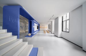 An elegant, minimalist space with white walls and flooring, featuring a modern interior design with clean lines and a sophist