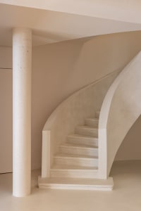 A modern staircase with concrete steps and walls.