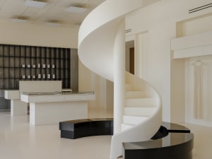 A modern retail shop featuring a white concrete staircase and black floating bench.