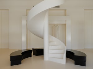 White minimalist retail space with a spiral staircase.