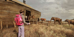 A photograph depicting a wooden structure with animals gathered on its roof.