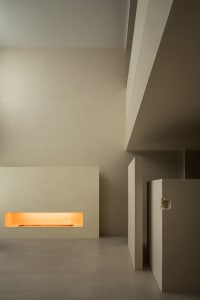 Modern minimalist interior space with minimalist furniture and concrete walls.
