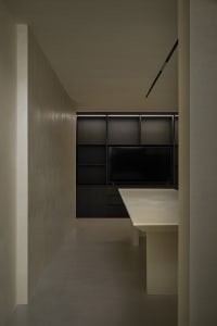 A modern kitchen with a concrete countertop and minimalist design.