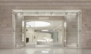 Modern, minimalist retail storefront with frameless glass doors and a contemporary interior design.