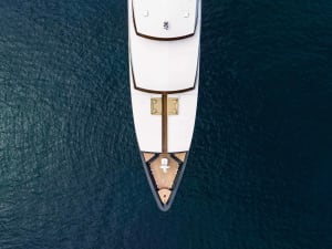 Aerial view of a white yacht looking down.