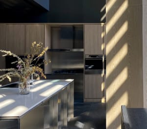 Contemporary kitchen featuring wooden cabinetry and stainless steel appliances