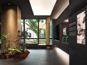 An indoor exhibit space featuring a modern design with concrete, glass, and steel materials.