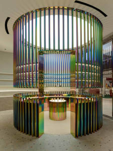 A luxurious retail shop interior featuring colorful metallic columns.