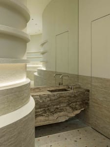 Modern bathroom design featuring sleek, curved terrazzo flooring and minimalist fixtures, creating a contemporary and luxurio