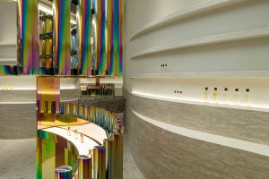 Modern retail storefront with metallic columns and concrete wall