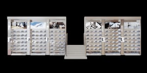 A shoe retail vending machine with steel and glass exteriors.