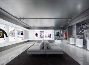 Modern retail interior with minimalist design, featuring a white and pastel color palette.