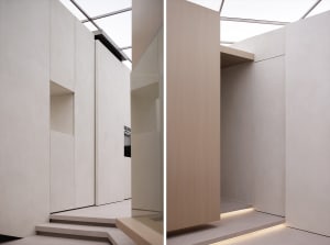 Modern minimalist interior with concrete walls and floor, featuring clean lines and a sleek design.