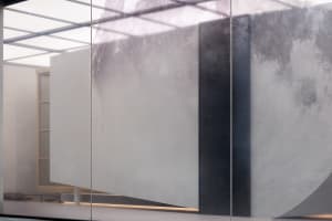 A modern interior space featuring a glass panel wall