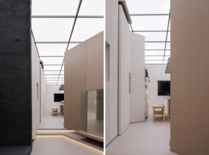 A minimalist interior with wooden panels and a glass wall.