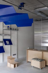 A modern office space featuring metallic blue shelves.