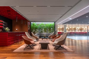 A modern lobby featuring concrete and wooden elements.