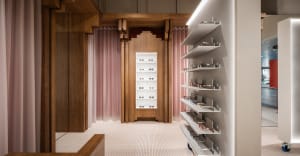 A modern retail interior featuring glasses on shelving and a wooden design aesthetic.