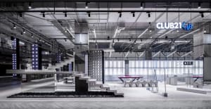 A minimalist retail interior with concrete elements and industrial lighting.