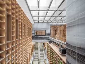 Photo of a spacious library with wooden shelves and modern design elements.