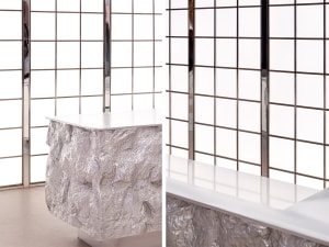 A modern interior design featuring an aluminum-foil textured counter.