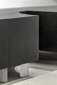 Modern, black-colored rectangular coffee table with metal legs.