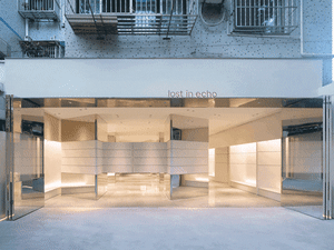A minimalist interior with glass and metal elements.