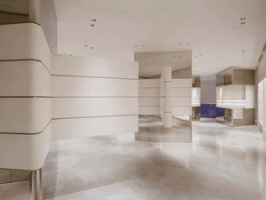 Modern, minimalist office space with concrete walls and floor.