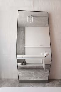 A modern spa interior with a textured concrete wall and minimalist design.