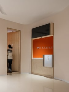 A commercial space with an orange acrylic background and metallic steel accents.